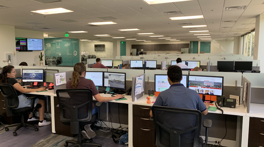 DigzyTech team working in a collaborative office environment, reflecting a professional and creative workplace culture.